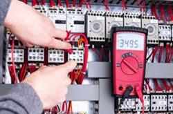 Electrician working on circuit board Selby